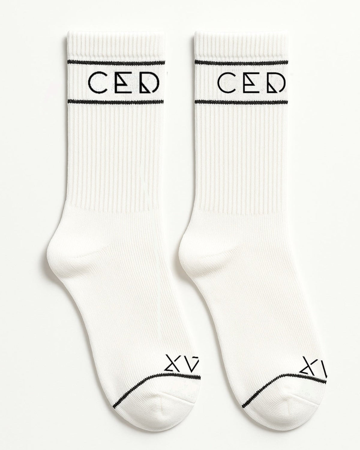 Pair of white ribbed crew socks with black CEDICI logo and minimalist XV design near the toes
